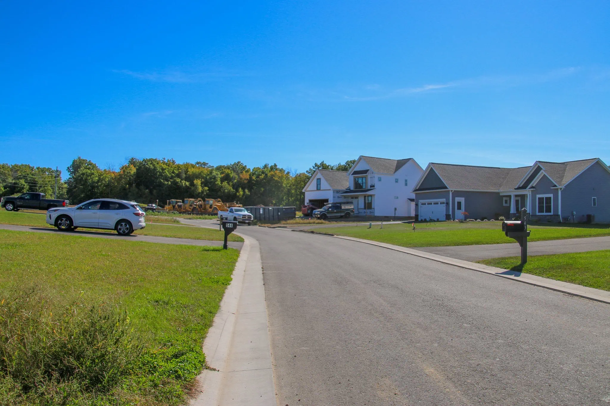 Residential street with completed and under-construction homes at The Meadows II subdivision