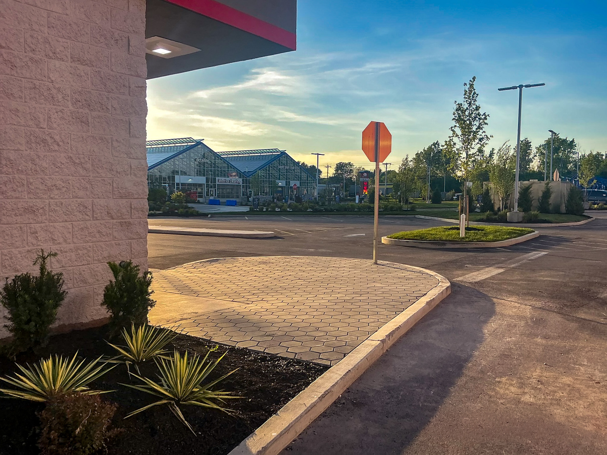 Delta Sonic West Henrietta entry area showing improved sight lines, hardscape design, ornamental plantings, and clear traffic flow from building perspective.